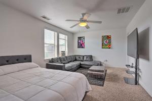 a bedroom with a bed and a flat screen tv at Spacious Denver Townhome Near Central Park! in Denver