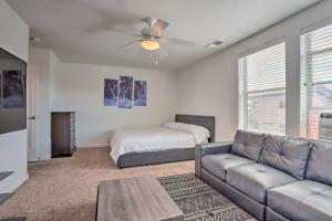 a living room with a couch and a bed at Spacious Denver Townhome Near Central Park! in Denver