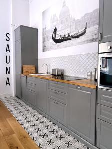a kitchen with a counter top with a sink and a sink at 1st Floor Apartment in Toruń