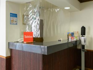 a counter with a plastic wrap on the wall at Tabist IWATA Station Hotel in Iwata