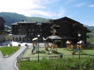a playground in front of a large building at Appartement Valmorel, 1 pièce, 4 personnes - FR-1-356-291 in Valmorel