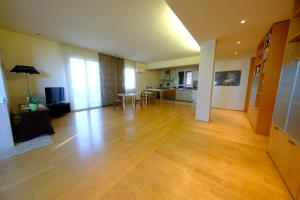 a living room with a hard wood floor and a kitchen at Sotto la luna Casa in campagna in Castel Bolognese +22 photos