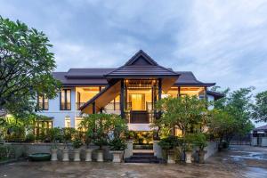 a large house with trees in front of it at Sclass 2 Luxe Pools Villa & Breakfast , city area in Chiang Mai