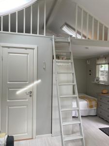 a bunk bed with a ladder in a bedroom at Ekverandan in Höganäs