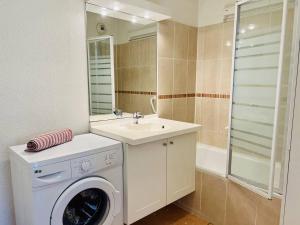 a bathroom with a washing machine and a sink at Appartement T2 avec Piscine, Proche Thermes, Parking Souterrain et Terrasse - Cambo-les-Bains - FR-1-495-72 in Cambo-les-Bains