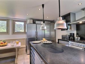 a kitchen with stainless steel appliances and a counter top at Chalet Les Gets, 8 pièces, 14 personnes - FR-1-627-1 in Les Gets
