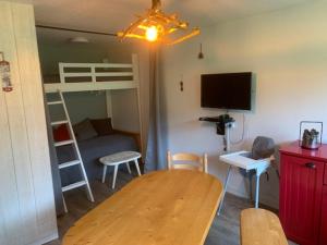 a small room with a table and a bunk bed at Appartement Mont-Dore, 2 pièces, 5 personnes - FR-1-415-114 in Le Mont-Dore