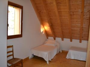 a room with two beds and a window and wooden ceilings at Chalet Albiez-Montrond, 4 pièces, 8 personnes - FR-1-618-16 in Albiez-Montrond