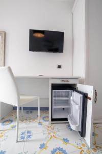 a kitchen with an open refrigerator and a chair at CASA ALBA D'ORO in Scala