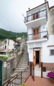 a white house with stairs and a balcony at CASA ALBA D'ORO in Scala