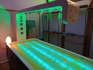 a bed in a room with green lights at B&B Cà d'Artisti in Caorle