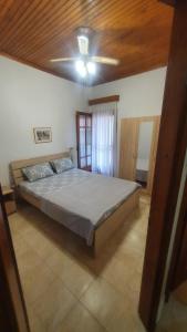 a large bed in a bedroom with a ceiling at Adorable 2 floors two bedroom vacation maisonette in Nea Potidaea