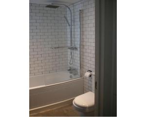 a bathroom with a toilet and a tub and a sink at Highday House - A Place To Escape To in Totnes