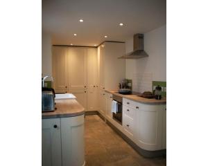 a kitchen with white cabinets and marble counter tops at Highday House - A Place To Escape To in Totnes