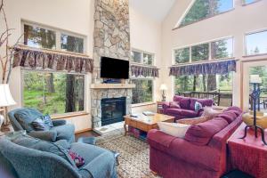 a living room with couches and a fireplace at Cedar House in McCall