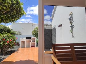 a view from the outside of a house with a window at Casa de los pajaritos. in Charco del Palo