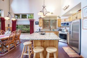 a kitchen with a large island with a counter top at Cedar House in McCall