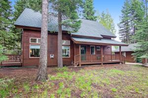 a large wooden house with a large porch at Cedar House in McCall