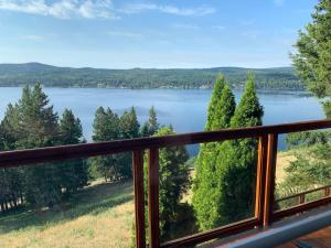 a view from the deck of a house overlooking a lake at The Horse Lake Inn in Lone Butte