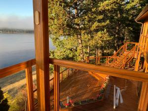 a view from the balcony of a cabin on a lake at The Horse Lake Inn in Lone Butte