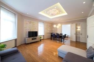 a living room with a couch and a tv at Agape Apartments in Zagreb