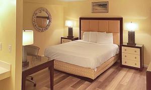 a bedroom with a bed with two night stands and two lamps at Vento Hotel in Hutchinson