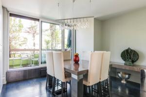 a dining room with a table and chairs at Penthouse champs elysées above 5 stars hotel berri champs elysées in Paris