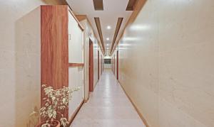 a corridor of a building with a plant at Itsy Hotels Sri Sai Grand Inn in Vijayawāda