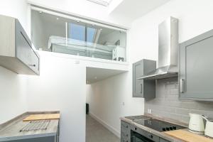 a kitchen with white walls and stainless steel appliances at King Pin Corner in Stevenage