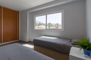 Krevet ili kreveti u jedinici u okviru objekta Rising Sun Apartments in complex Las Terrazas