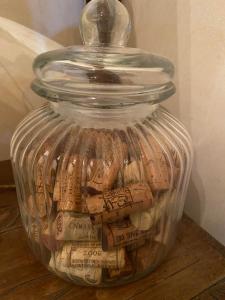 a glass jar filled with wine corks at Le pigeonnier de Saint-Loup Bed and Breakfast in Saint-Loup-de-Varenne