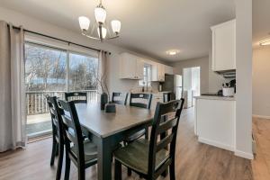 a kitchen and dining room with a table and chairs at 3 BR Private Pondside View New Reno [Moose Lodge] in Bar Harbor
