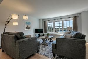 a living room with two chairs and a tv at 3 BR Private Pondside View New Reno [Moose Lodge] in Bar Harbor