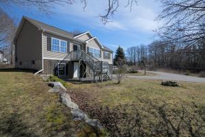 a large house with a porch and a driveway at 3 BR Private Pondside View New Reno [Moose Lodge] in Bar Harbor