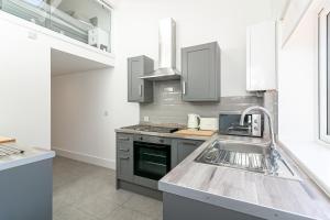 a kitchen with a sink and a stove at King Pin Corner in Stevenage