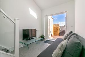 a living room with a couch and a television at King Pin Corner in Stevenage