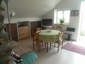 a kitchen and dining room with a table and chairs at Les Gites de Kerroyal in Garlan