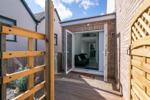 a wooden deck with a sliding glass door at King Pin Corner in Stevenage