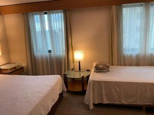 En eller flere senge i et værelse på Ibirapuera hotel 5 estrelas 2 suites