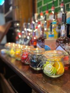 a counter with jars of fruit and vegetables on it at Red Lion in Bakewell