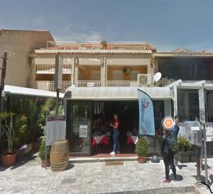 a man standing in front of a building at Casa Vacanze Amici dell' Etna in Giardini Naxos