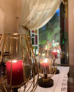 a group of three candles on a table at Dar Riad Niama in Taroudant +79 photos