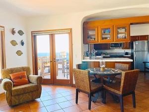 a living room with a table and chairs and a kitchen at Sunrise Bliss Villa in Avalon