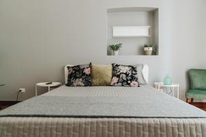 a bedroom with a bed and a green chair at AURA in Terlizzi