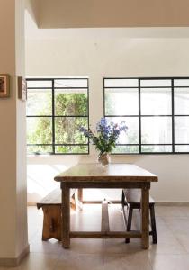 a room with a table with a vase of flowers on it at CHARMING APARTMENT AT UNBEATABLE SPOT in Tel Aviv