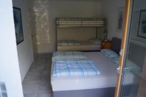 a room with three bunk beds in it at Ferienwohnung Birkenried in Reisensburg