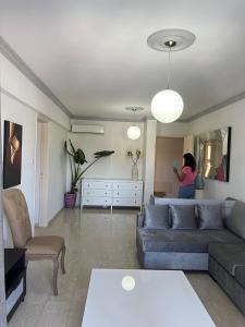 a woman in a living room with a couch at Luxury 3 bedroom apartment in Nicosia City Center in Nicosia