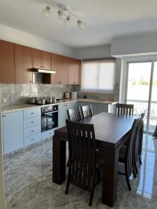a kitchen with a dining room table and chairs at Luxury 3 bedroom apartment in Nicosia City Center in Nicosia