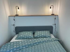 a bed with two lights on top of it at Appartement Rosa in Patergassen