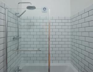a shower with a glass door in a bathroom at Modern Apartment In The Centre of Teignmouth in Teignmouth